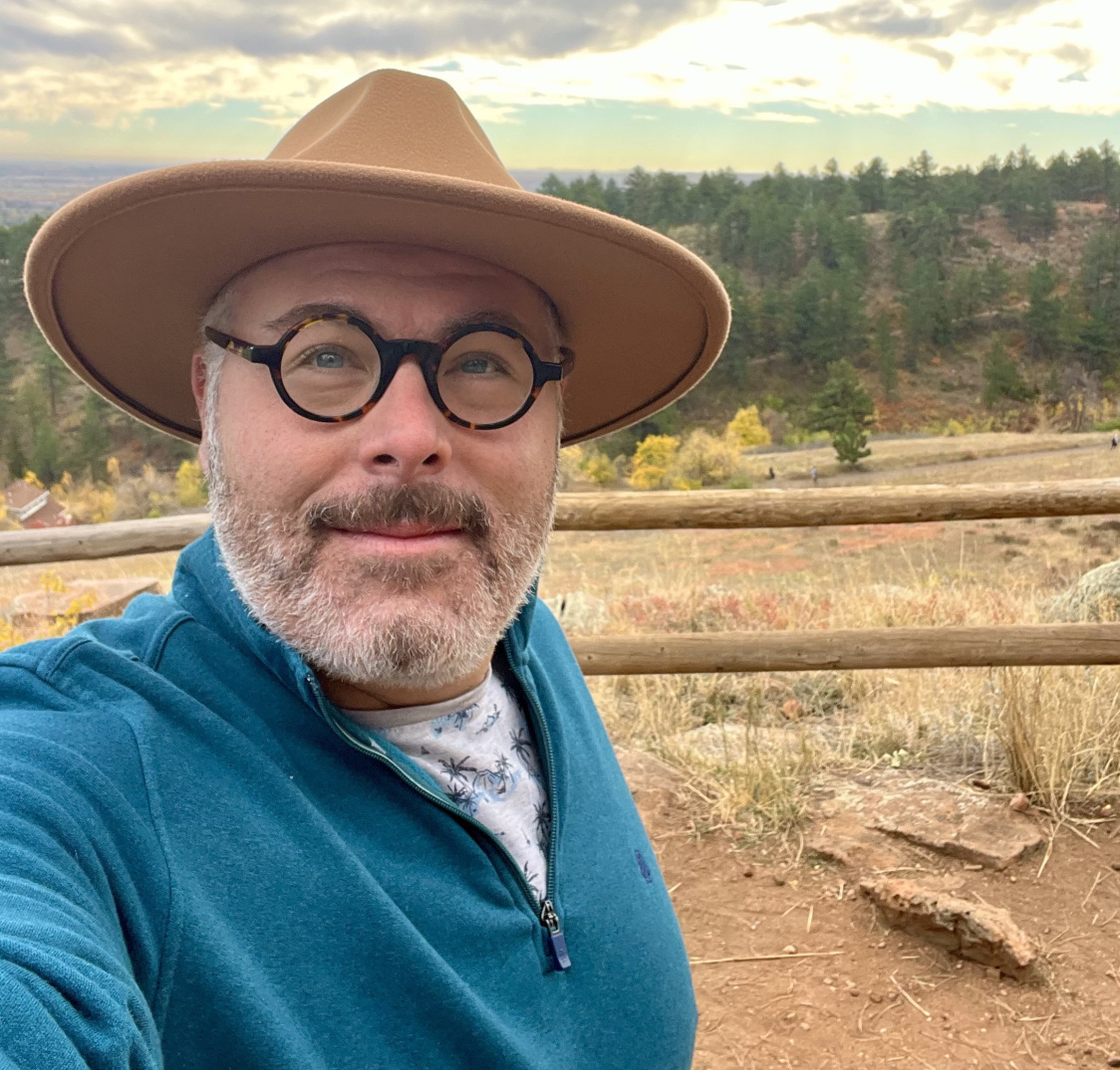 Photo of Chad Elish, Blue Polo Shirt, Blue Glasses